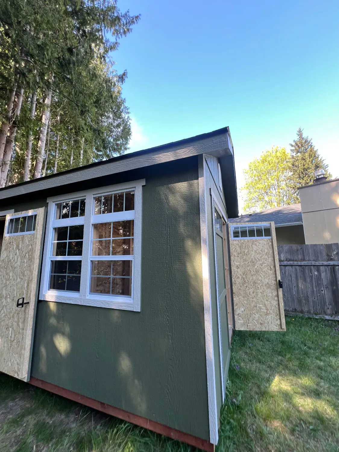 Detached shed not matching new house siding color in Maple Valley WA backyard
