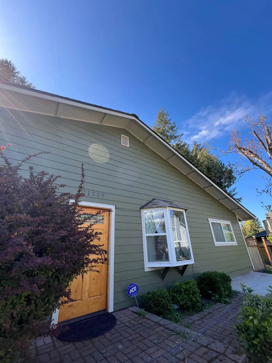 Painter color matching exterior trim to new siding on Maple Valley WA home