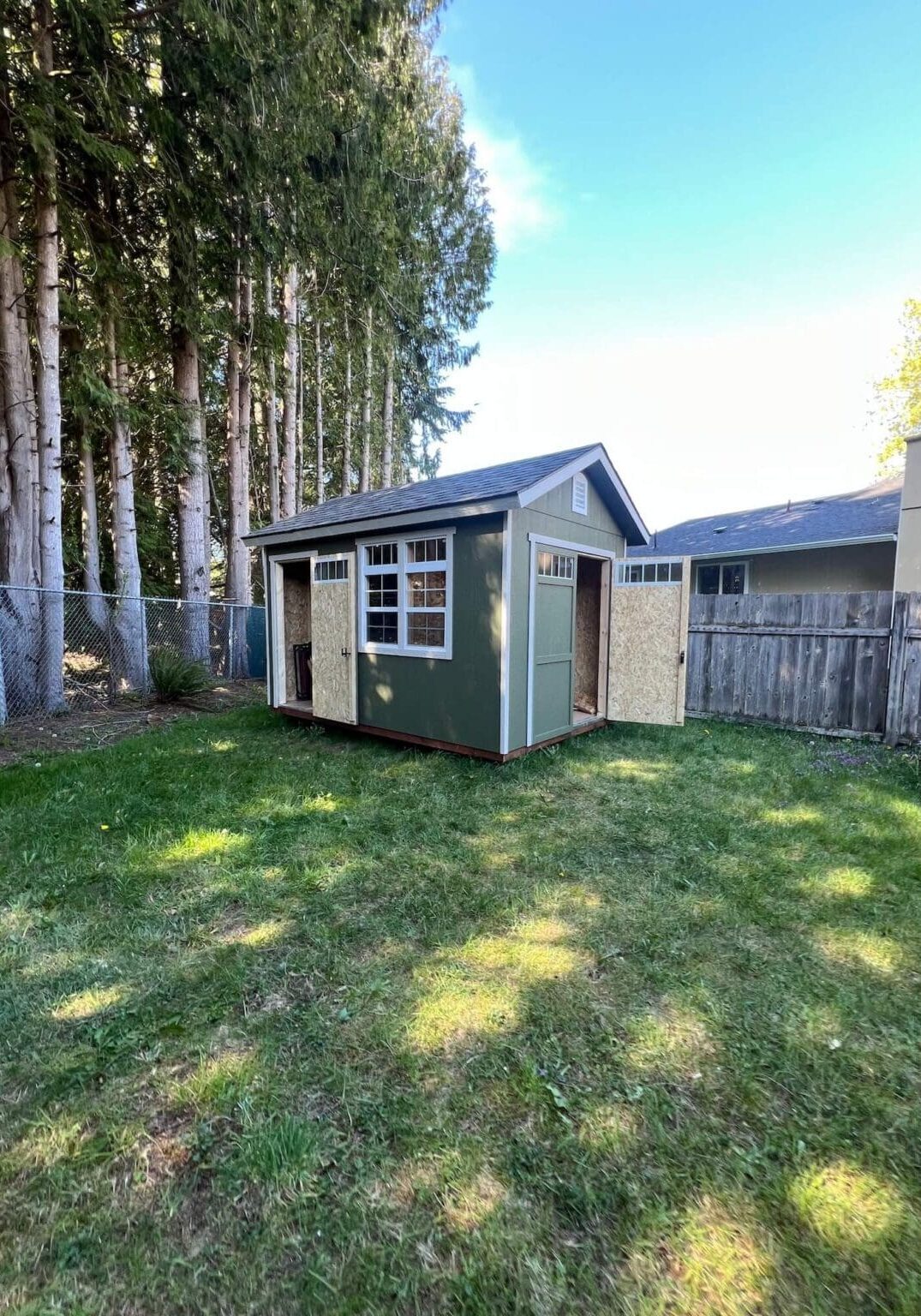 Repainted backyard shed matching the main house exterior in Maple Valley WA